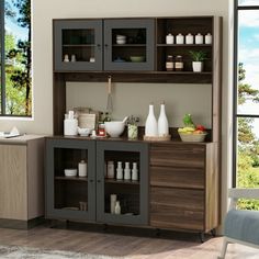 a kitchen with wooden cabinets and shelves filled with dishes on top of each cabinet in front of a large window