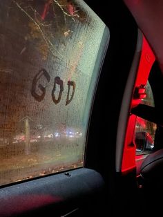 the word god is etched in frosted glass on a car's side window