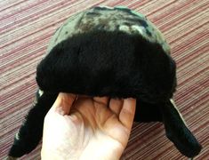 Green fleece camouflage trapper cap with black plush lining and faux fur ear flaps. Ties at the chin. One adult size. The last photo shows the hat's back. Please take a look at my storefront at: https://www.etsy.com/shop/FabFinds42?ref=seller-platform-mcnav I have a wide selection of one-of-a-kind items, from clothing and toys to home decor and gift items, and I add new things almost every day. Black Hunting Cap, Camouflage Hat, Frog Costume, Mid Century Clock, Green Cap, Ear Flap Hats, Trapper Hats, Fleece Hat, Retro Clock