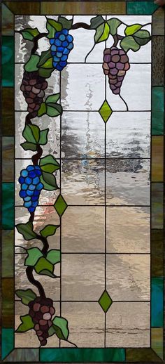 a stained glass window with grapes on it