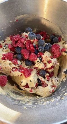 berries and blueberries are mixed together in a metal bowl on the stove top, ready to be cooked