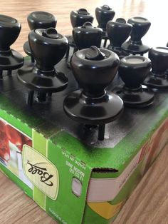 an unopened box with many black knobs on it's sides and inside