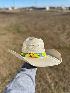 Add a touch of nature to your hat with our Sunflower Hatband. Handcrafted with intricate sunflower beads, this hat band is the perfect accessory for any outdoor excursion. The black leather ends add an extra 11 1/2 inches, providing a comfortable and secure fit. The whole hat band measures 30 1/2 inches, making it versatile for all hat sizes. Country Style Hat Bands For Outdoor, Southern Style Adjustable Straw Hat For Ranch, Adjustable Western Sun Hat For Kentucky Derby, Adjustable Hat Bands For Kentucky Derby, Western Style Beach Hat Bands With Adjustable Fit, Bohemian Natural Hat Bands For Outdoor Use, Adjustable Country Hats For Outdoor, Bohemian Natural Hat Bands For Outdoor, Southern Style Adjustable Hat With Short Brim