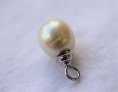 The size of the South Sea pearl is approximately 11.5mm. The pearl is teardrop shape, has a silver, very light pink overtone with high luster. The top of the bail to the bottom of the pearl is approximately 7/8 inch long. It comes with a 16 inch 14K white gold chain. Please visit our shop policies for more details! All items are in stock and ready to ship as soon as I have received payment. For more information, Like us on Facebook, follow us on Instagram or visit our website www.ikedapearl.com White Gold Drop Pearl Necklace, White Gold Teardrop Pearl Necklace, Teardrop Akoya Pearl Necklace, White Gold Teardrop Pearl Necklace With Charm, Classic Teardrop White Gold Pearl Necklace, Classic White Gold Teardrop Pearl Necklace, White Gold Pearl Charm Necklace, White Gold Pearl Necklace With Pear-shaped Charm, Pear-shaped White Gold Pearl Necklace With Charm