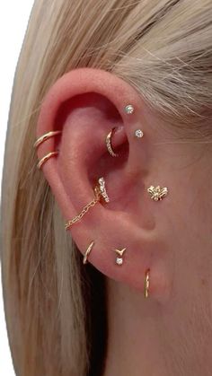 a woman's ear with three different types of piercings