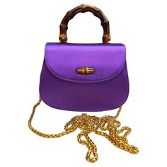 This vintage GUCCI micro two-way evening handbag is crafted of satin in purple and a bamboo handle featuring gold toned hardware. Front flap magnetic bamboo snap closure opens to a satin interior with a patch pocket. This micro bamboo bag also features a detachable gold toned chain for carrying on the shoulder. Made in Italy. Measures approximately 5.5 x 4.5 x 1.25 inches. Comes with dust bag. Condition - Very good vintage condition with minor signs of wear Outside: Very minor marks Inside: Mini Fendi Pouch, Gucci Top Handle Bag, Gucci Top, Gucci Mini, Micro Bag, Bamboo Bag, Gucci Outfits, Gucci Tote, Evening Handbag