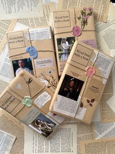 some old books are laying on top of an open book with paper flowers and buttons