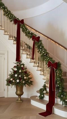 a staircase decorated for christmas with garland and bows