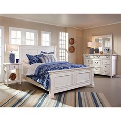 a bedroom with white furniture and blue bedding