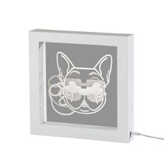 a cat with glasses is shown in a white frame and has wires attached to it