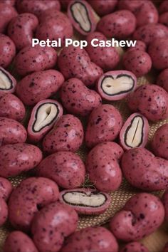 red and black speckled nuts are on display for sale at the petal pop cashew