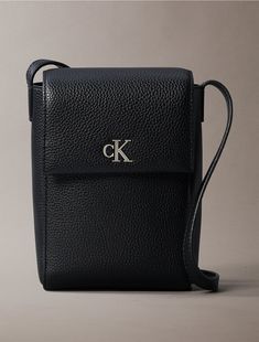 A crossbody bag made with a top flap closure and shoulder strap. Shaped with a slim, boxy profile to perfectly fit your smartphone. Finished with a CK monogram logo design at the front.  Material: 100% Polyurethane. Calvin Klein Crossbody Bag, Chic Calvin Klein Crossbody Shoulder Bag, Calvin Klein Crossbody Bag For Daily Use, Calvin Klein Crossbody Shoulder Bag With Adjustable Strap, Calvin Klein Crossbody Bag With Adjustable Strap, Monogram Logo Design, Monogram Logo, Bag Making, Calvin Klein