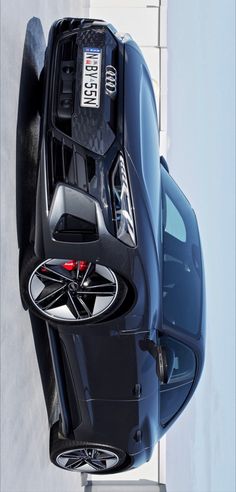 the top view of a car parked in front of a building with it's hood up