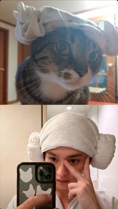 a woman taking a selfie with her cat wearing a towel on top of her head