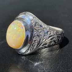 925 STERLING SILVER MEN'S RING WITH NATURAL OPAL Quality meets perfection Handcrafted by Turkish artisan jewelers Unique collectors item METAL : .925 Sterling Silver GEMSTONE: Opal (origin: Africa) DIMENSIONS OF STONES: 10x14 mm SIZE: US 10 Sterling Silver Mens Rings, Mens Silver Rings, Sterling Silver Mens, Men's Ring, Natural Opal, Silver Man, Metal Jewelry, Artisan Jewelry, Opal