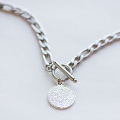 Silver Toggle Necklace that you can wear everyday. The Phaistos pendant is made of 925 sterling silver and the chain is made of stainless steel. The necklace is very durable and hypoallergenic. It is water-resistant, nickel free and lead free. Also available in gold. The pendant measures 18 mm and the figaro chain is 6 mm thick. ★ IMPORTANT INFORMATION ★ ✩ Please review our shop policies page prior to purchase ► https://www.etsy.com/shop/OlizzJewelry/policy ✩ Convo me for custom orders. ★ ENTER Christmas Present For Best Friend, Present For Best Friend, Pearl Ankle Bracelet, Silver Lariat Necklace, Toggle Clasp Necklace, Lariat Necklace Silver, Presents For Best Friends, Birthday Gift For Mom, Toggle Necklace