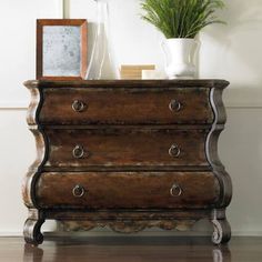 an old chest of drawers with plants on top