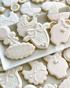 some cookies are laying on a plate and one is decorated with baby's names