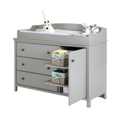 a baby's changing table with drawers and toys in the bottom drawer, on an isolated white background