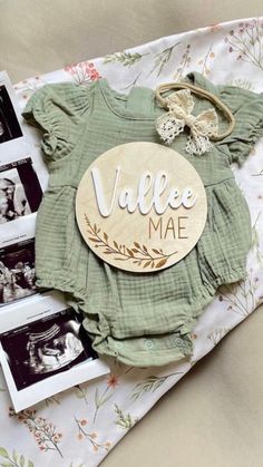 some clothes and pictures are laying on a table with the name vale mae written on it