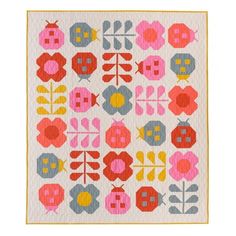 a colorful quilt with flowers and leaves on the front, in pink, blue, yellow and red