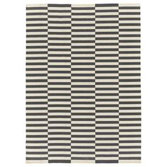 a black and white rug with vertical stripes on it's side, in the shape of a checkerboard pattern