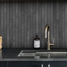 a kitchen sink with a bottle of soap next to the faucet and cutting board