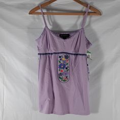 Nwt Inc International Concepts Purple With Embroidered Flowers Hanging From Bustling Sz M And L. Adjustable Shoulder Straps. Approximate Measurements: Sizes. M L Pit - Pit Across. 16" 17" Pit - Hem. 17.5" 18" Waist Across. 18" 20" Ab - 43. Ab - 44 Embroidered V-neck Tank Top For Spring, Embroidered Cotton Tank Top For Beach, Summer Embroidered Camisole Tank Top, Fitted Cotton Tank Top With Floral Embroidery, Embroidered Camisole Tank Top For Summer, Spring Purple Cotton Tank Top, Spring Embroidered Camisole Top, Purple Cotton Tank Top For Spring, Embroidered Camisole Tops For Spring