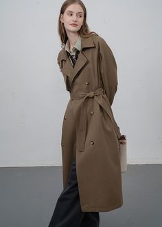 Command the rainy streets in style with our Storm Flap Double Breasted Long Trench Coat. Sophisticated and functional, this women's coat features a gun flap and storm flap for ultimate protection from the elements. The belted waist and longline design create a flattering silhouette, making this coat a must-have for any fashion-forward individual. ●Long sleeves●Front double-breasted button closure●Notched lapels●Front seam pockets●Lined●Polyester, spandex●Machine wash●Item #492341 SIZE INFO XS=US Double-breasted Fall Workwear Raincoat, Fall Workwear Double-breasted Raincoat, Belted Khaki Outerwear For Business, Winter Workwear Belted Raincoat, Belted Long Raincoat For Fall, Khaki Outerwear For Rainy Fall Weather, Business Long Raincoat For Fall, Long Business Raincoat For Fall, Winter Utility Raincoat For Workwear