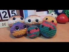 four crocheted stuffed animals sitting next to each other on top of a table