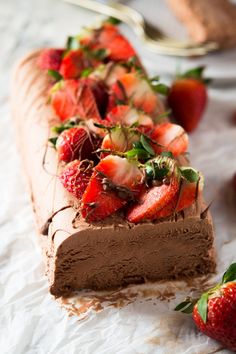 a chocolate cake with strawberries on top