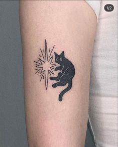 a black cat is sitting on the arm with a star in it's paw