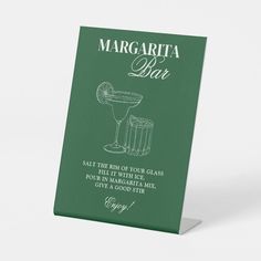 a green margarita bar sign on a white background