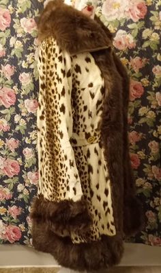 This coat is wildly fantastic in so many ways and will be a huge hit casual or dressed up. It has so much paxzaz going on from the fun animal print to the thick faux fur trim, gold button details, 70s collar and bell sleeves. Size small/medium Measurements: 34' long Shoulder to shoulder 16' Arms 22' Bell sleeves 8' Waist 15.5' Pit to pit 18' Light to Medium weight Made in Scotland Furrier cleaning recommended Animal Print Clothes Aesthetic, Fitted Retro Fur Coat For Fall, Retro Fitted Brown Fur Coat, Retro Brown Fitted Fur Coat, Vintage Leopard Print Winter Outerwear, Vintage Leopard Print Outerwear For Winter, Fitted Faux Fur Outerwear In Leopard Print, Fitted Leopard Print Faux Fur Outerwear, Retro Fitted Fur Coat With Faux Fur Trim