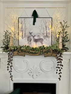 a christmas mantle decorated with greenery and deers in front of a fireplace mantel