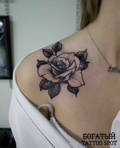 a woman with a rose tattoo on her shoulder