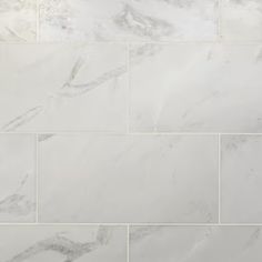 a white marble tile wall and floor