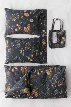 three pieces of black and yellow flowers on a white sheet with a bag next to it