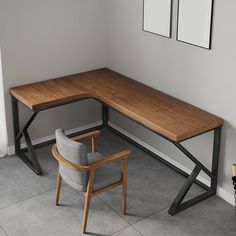 a corner desk with a chair next to it and two framed pictures on the wall