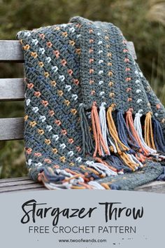 a crocheted blanket sitting on top of a wooden bench with text overlay that reads stargazer throw free crochet pattern