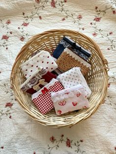 a basket filled with lots of different types of cloths on top of a table