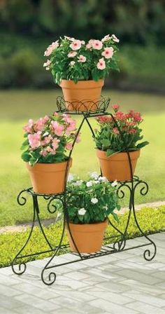 three tiered potted plant stand with pink and white flowers