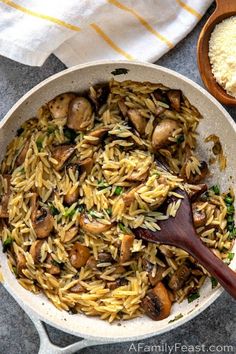 a skillet filled with pasta and mushrooms