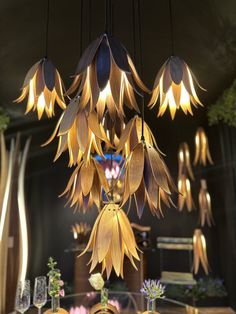 a chandelier hanging from the ceiling in a room with many flowers on it