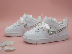 Custom crystal bling baby and toddler low top Nike. Hand embellished with the the finest crystals to all 4 Nike ticks and finished with white satin ribbon laces. If you would like different crystal or ribbon colour, please just message. Orders are taken in UK sizing and an international conversion and measurement chart is attached for reference. Bling Baby Shoes, Low Top Nikes, Baby Nike, Toddler Nikes, Top Nike, Shoes Custom, Crib Shoes, Shoes Booties