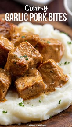 A wooden plate has mashed potatoes, and garlic pork bites on it. Cube Pork Chop Recipes, 30 Minute Meals Pork Chops, Pork Tenderloin Cubes Recipes, Pork Loin Cubes Recipes, Creamy Garlic Pork Bites, Pork Chop Bites Crock Pot, Pork Chops From Pork Loin, Pork Chop And Sausage Recipes, Recipes With Cubed Pork