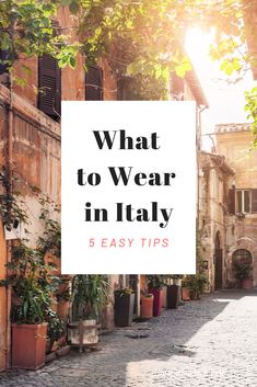 the words what to wear in italy 5 easy tips on an old cobblestone street