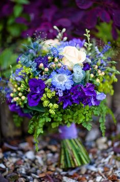 a bouquet of blue flowers and greenery