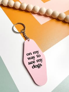 a pink keychain with the words on my way to see my dogs written on it