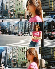 the girl is standing on the street corner in front of some tall buildings and cars